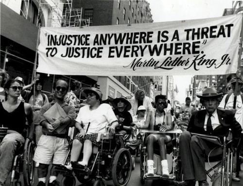 Photo credit: Judy Heumann pictured alongside members of Disabled In Action, a disability justice organization she founded, protesting the delaying of the passing of Section 504 in Madison Avenue, New York in 1970. (Source: Tari Hartman Squire)