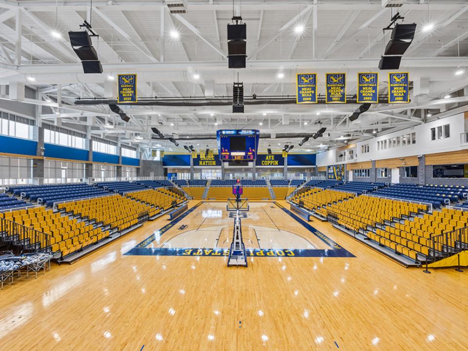 Physical Education Complex Arena. Yellow and blue seating with Coppin State printed on the arena floor
