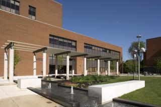 The grass, trees, fountains, and sitting areas directly in front of the Grace Jacobs Building on the Coppin State University campus.