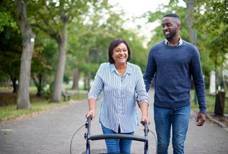 Disable women walking with a man through the park