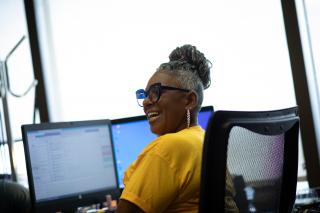 Woman sitting around Computer Smiling