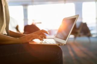 Typing on laptop while sun is setting